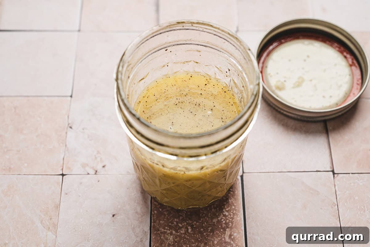 A homemade maroulosalata dressing in a mason jar.