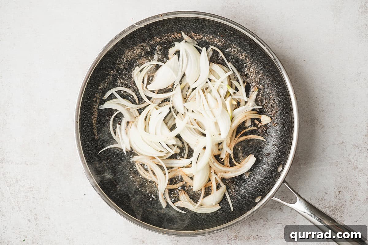 Sliced onions in a skillet.