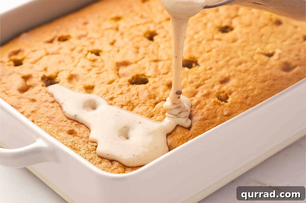Decadent Cannoli Cake Recipe with Ricotta Filling and Crisp Shells 7 Pouring sweetened condensed milk over a poke cake