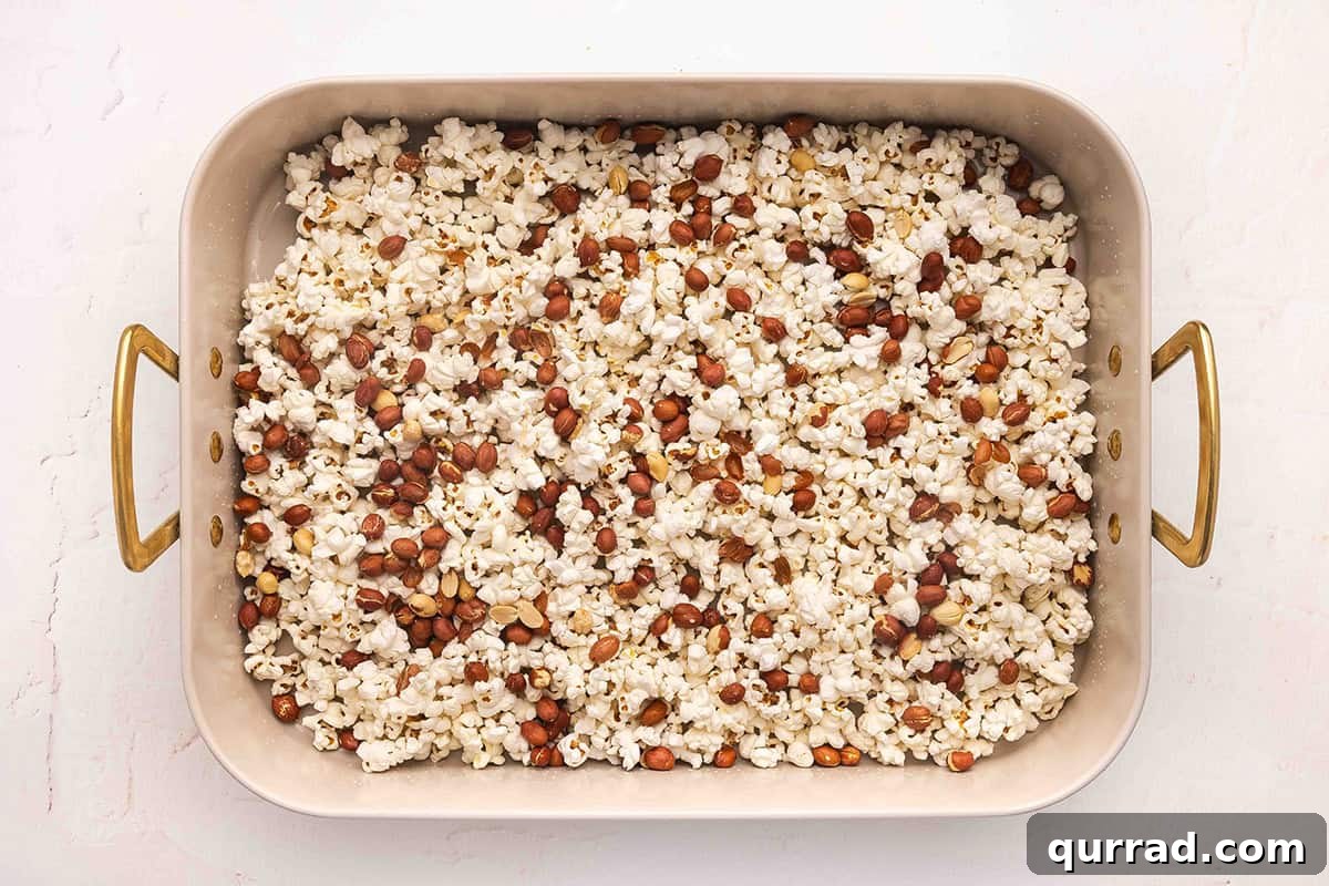 Popcorn and roasted peanuts on a baking sheet.