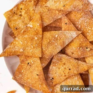 Overhead view of air fryer wonton chips on a plate.