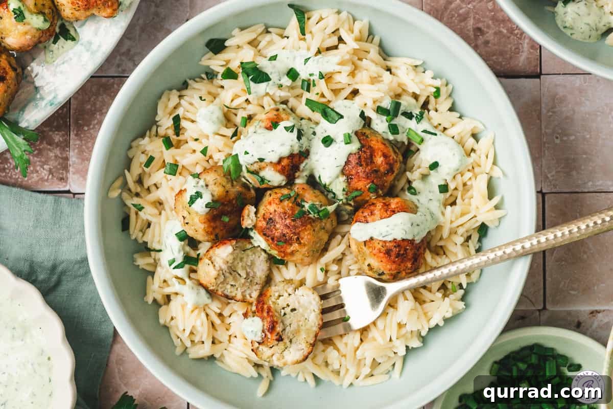 Green goddess meatballs on a plate with cooked orzo.