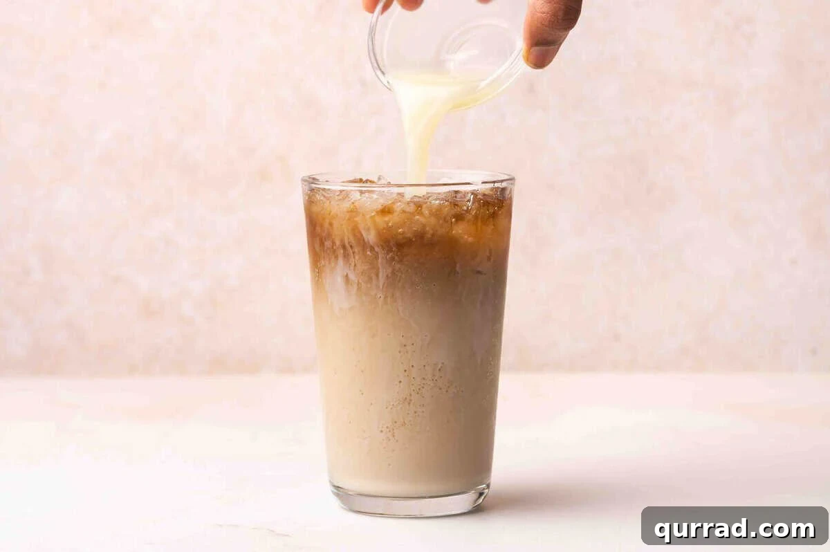 Lime juice being added to a glass of dr pepper.