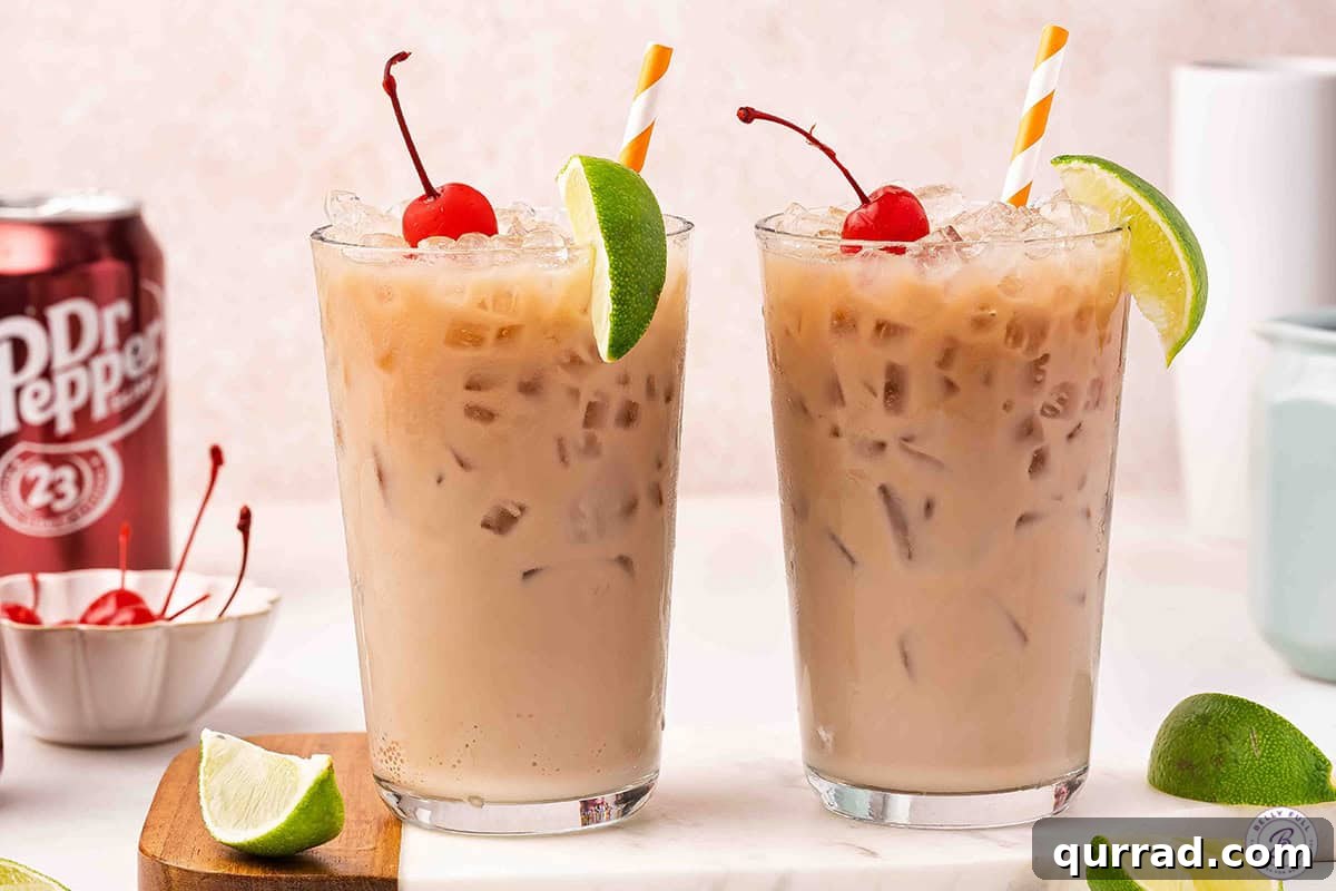 2 dirty soda drinks garnished with a lime wedge and cherry