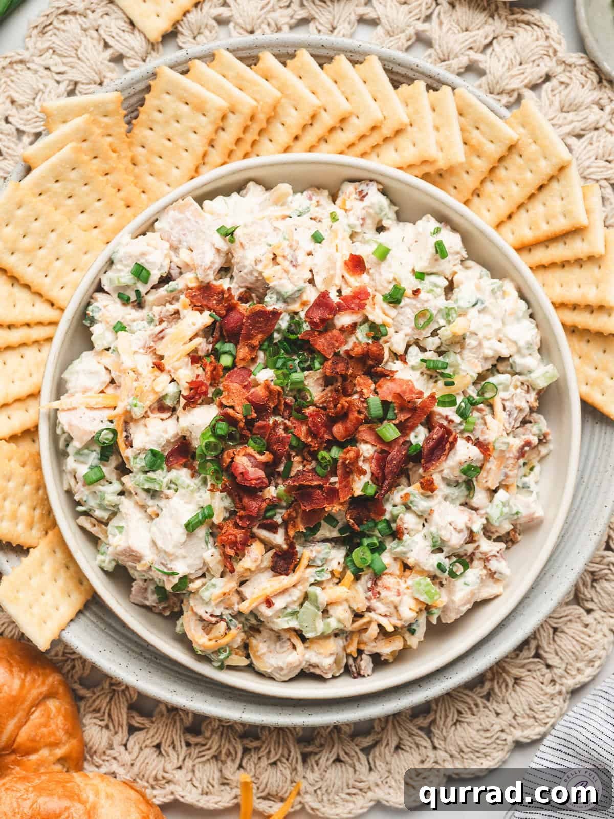 Million-Dollar Chicken Salad Recipe You'll Love 2 Overhead view of a bowl of million dollar chicken salad with crackers.