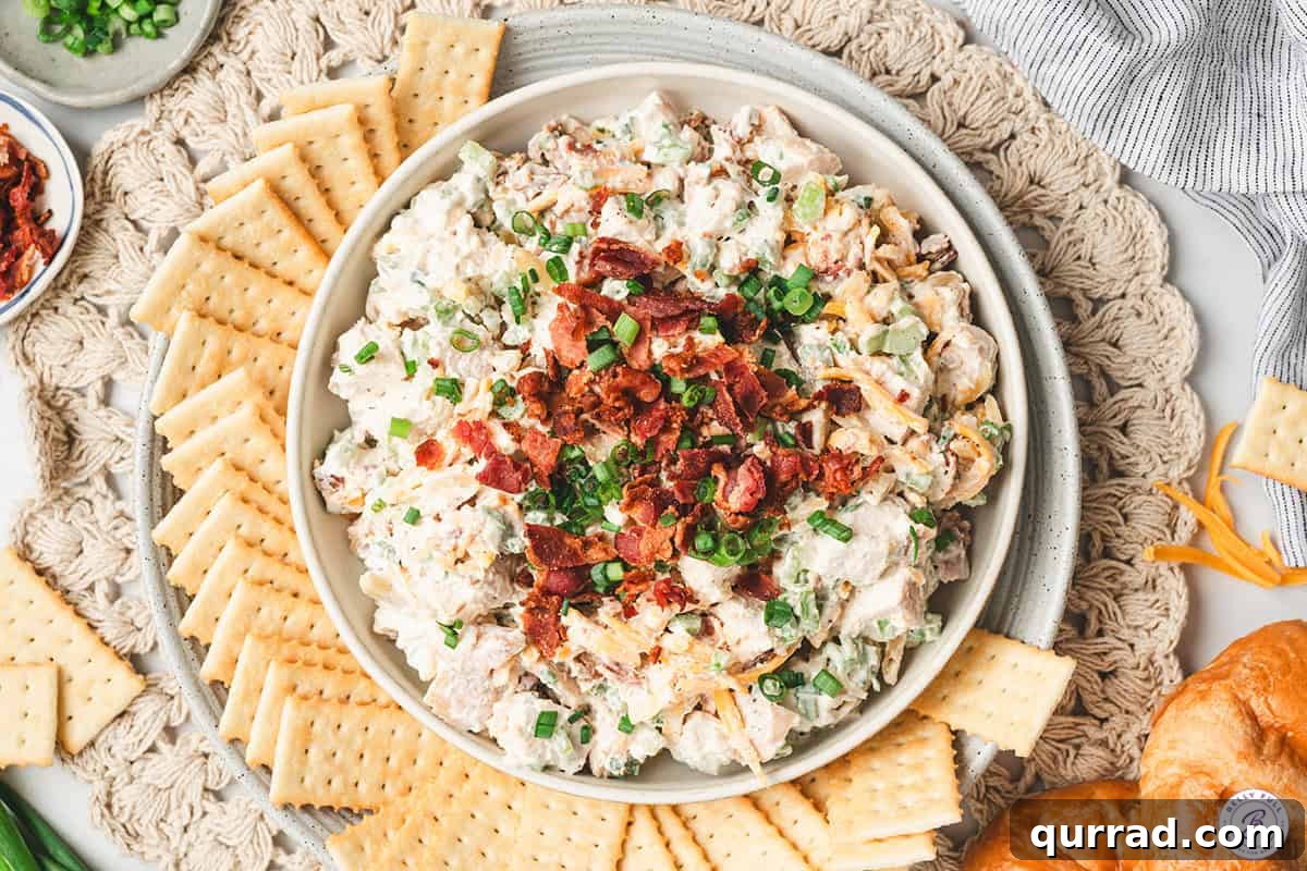 Million-Dollar Chicken Salad Recipe You'll Love 8 A bowl of million dollar chicken salad with crackers.