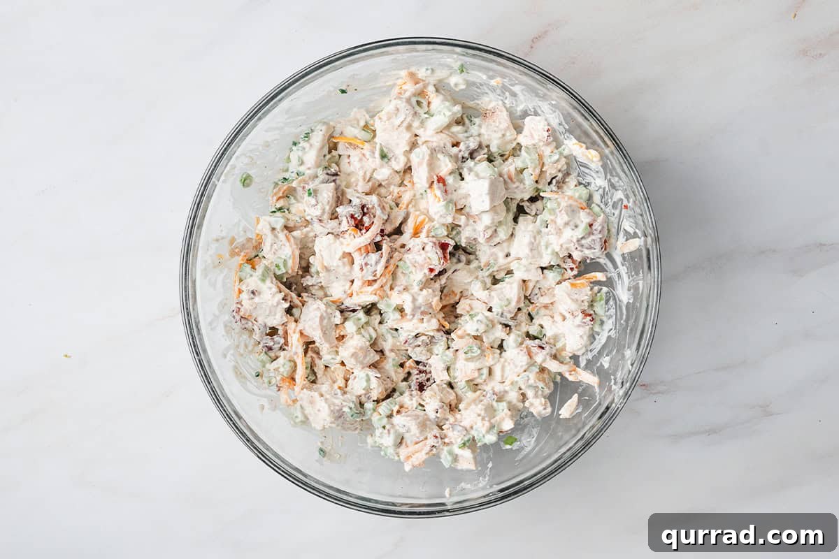Million-Dollar Chicken Salad Recipe You'll Love 7 Overhead view of a bowl of million dollar chicken salad.