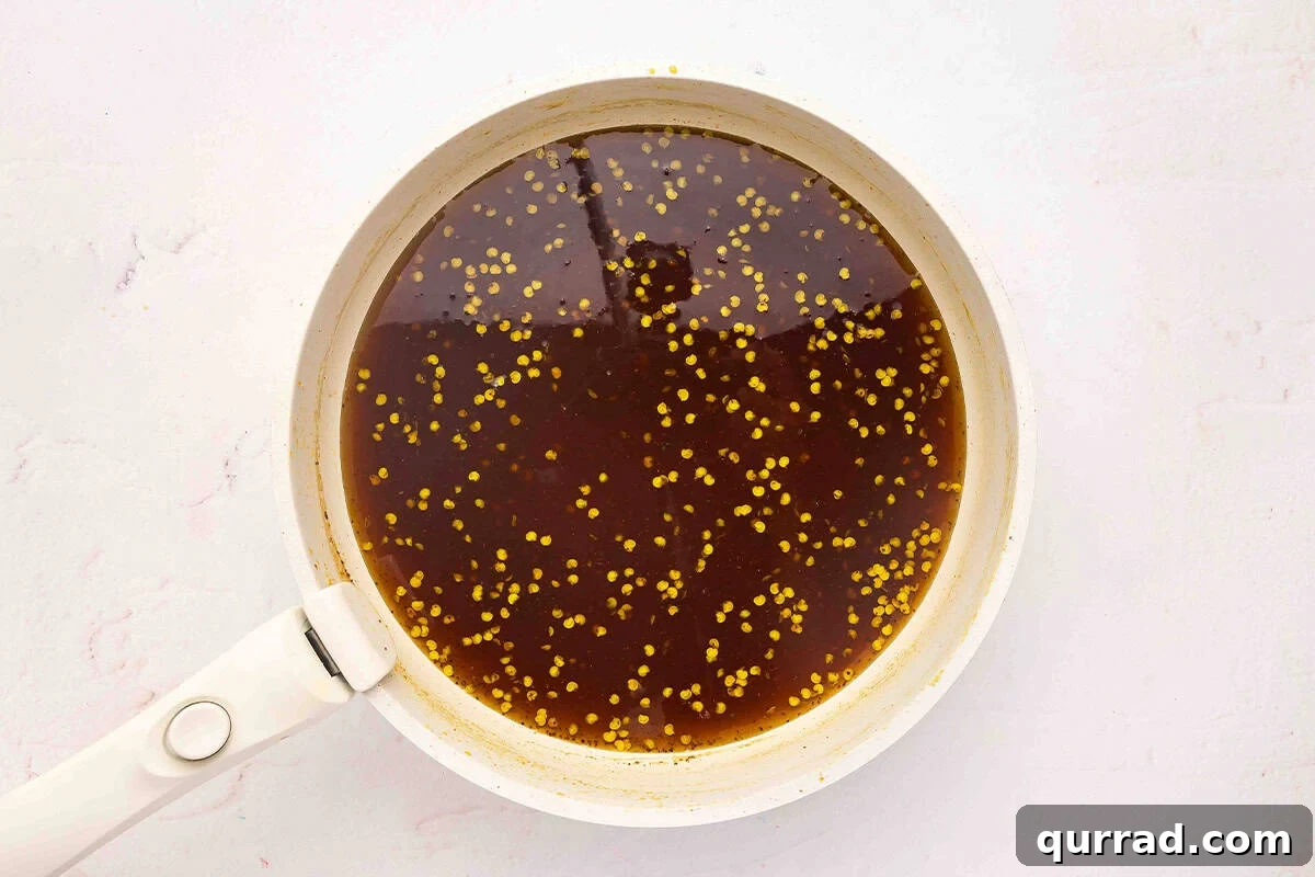 Cowgirl Candy Jalapeno Pepper Jelly Recipe 10 Jalapeno syrup in a sauce pan.