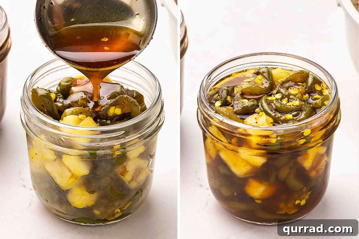 Cowgirl Candy Jalapeno Pepper Jelly Recipe 11 A ladle pouring syrup into a jar with jalapenos and pineapple.