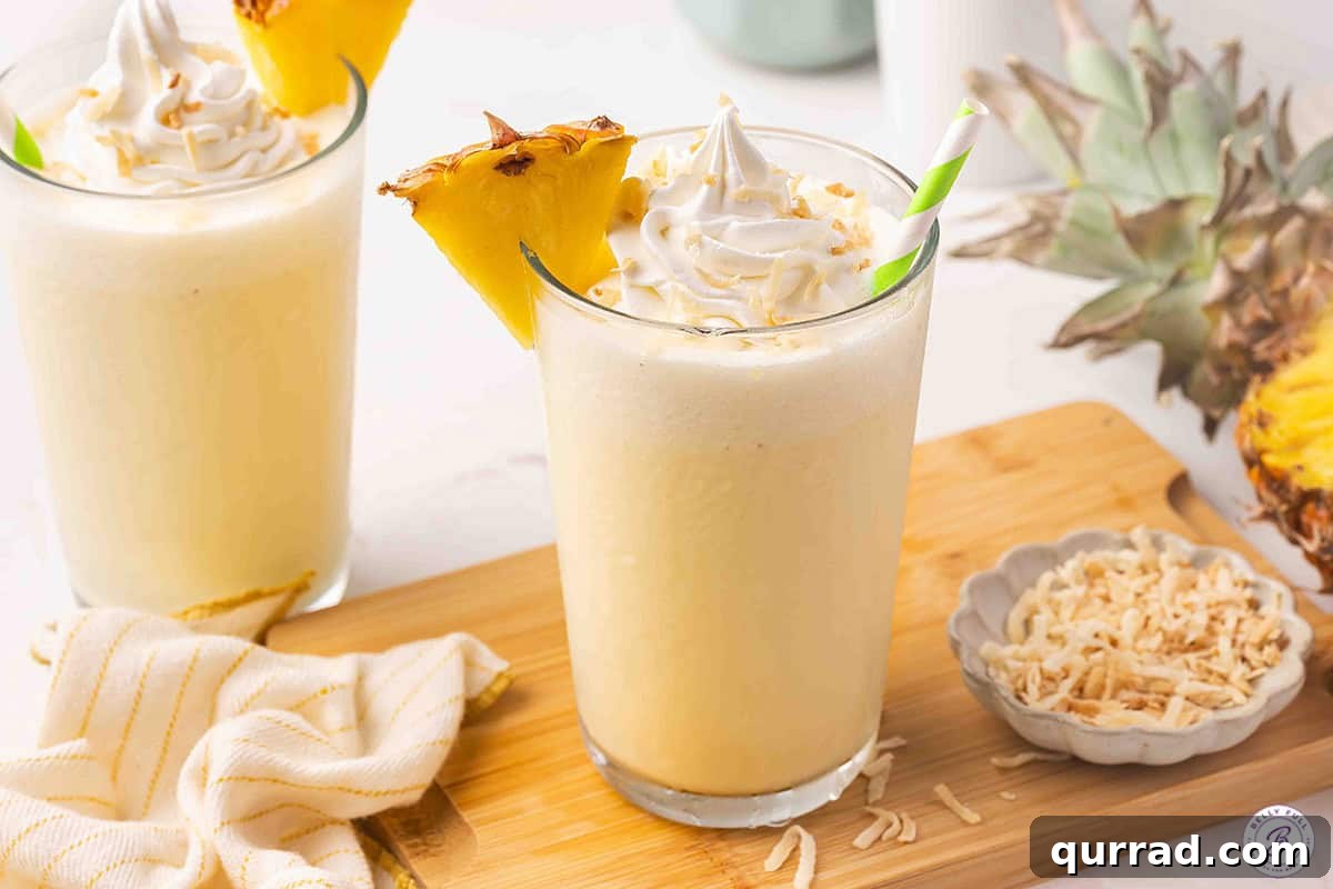 Side view of a pineapple coconut orange julius.
