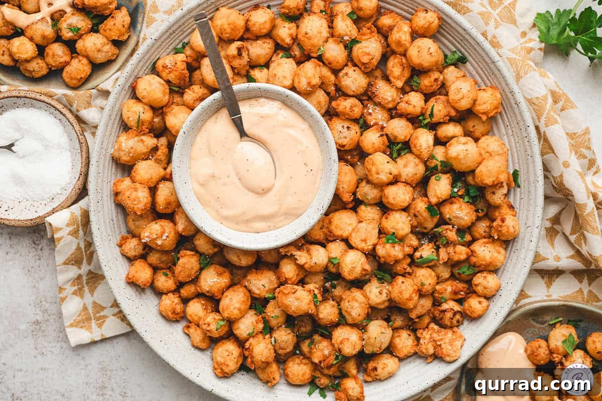Bloomin onion bites on a plate with comeback sauce.