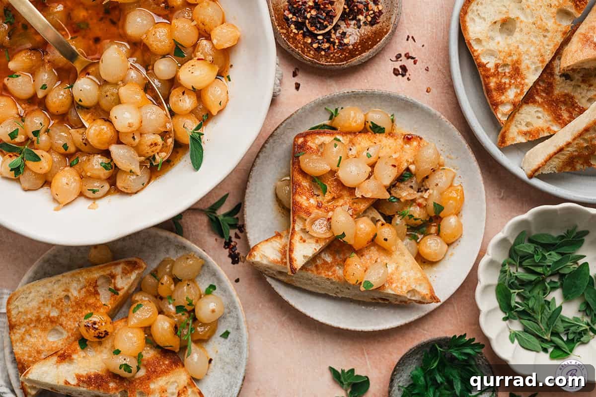 One-Pot Mini Pearl Onion Boil with Garlic and Herbs 9 Mini onion boil on toast on a plate.