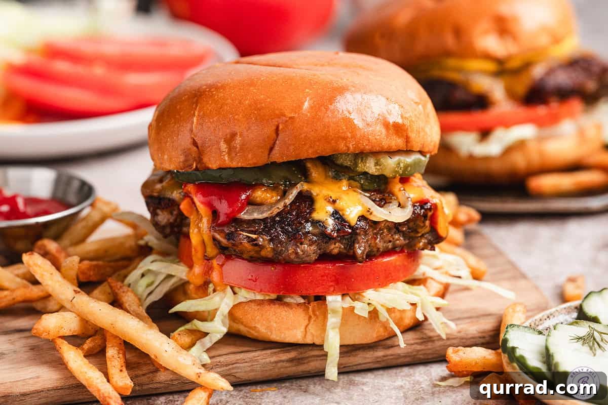 Side view of a crack smash burger with fries.