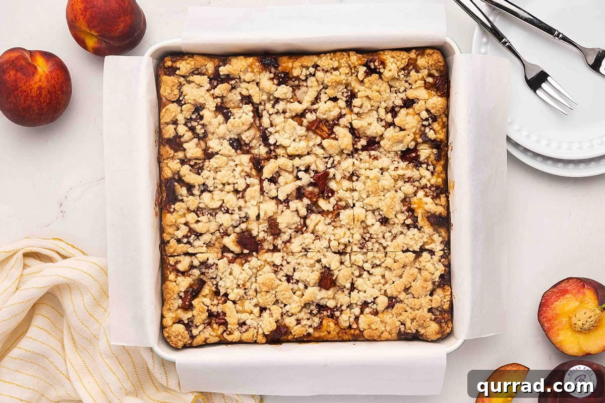 Irresistible Peach Cobbler Cheesecake Bars 11 Overhead view of peach cobbler cheesecake bars before slicing.