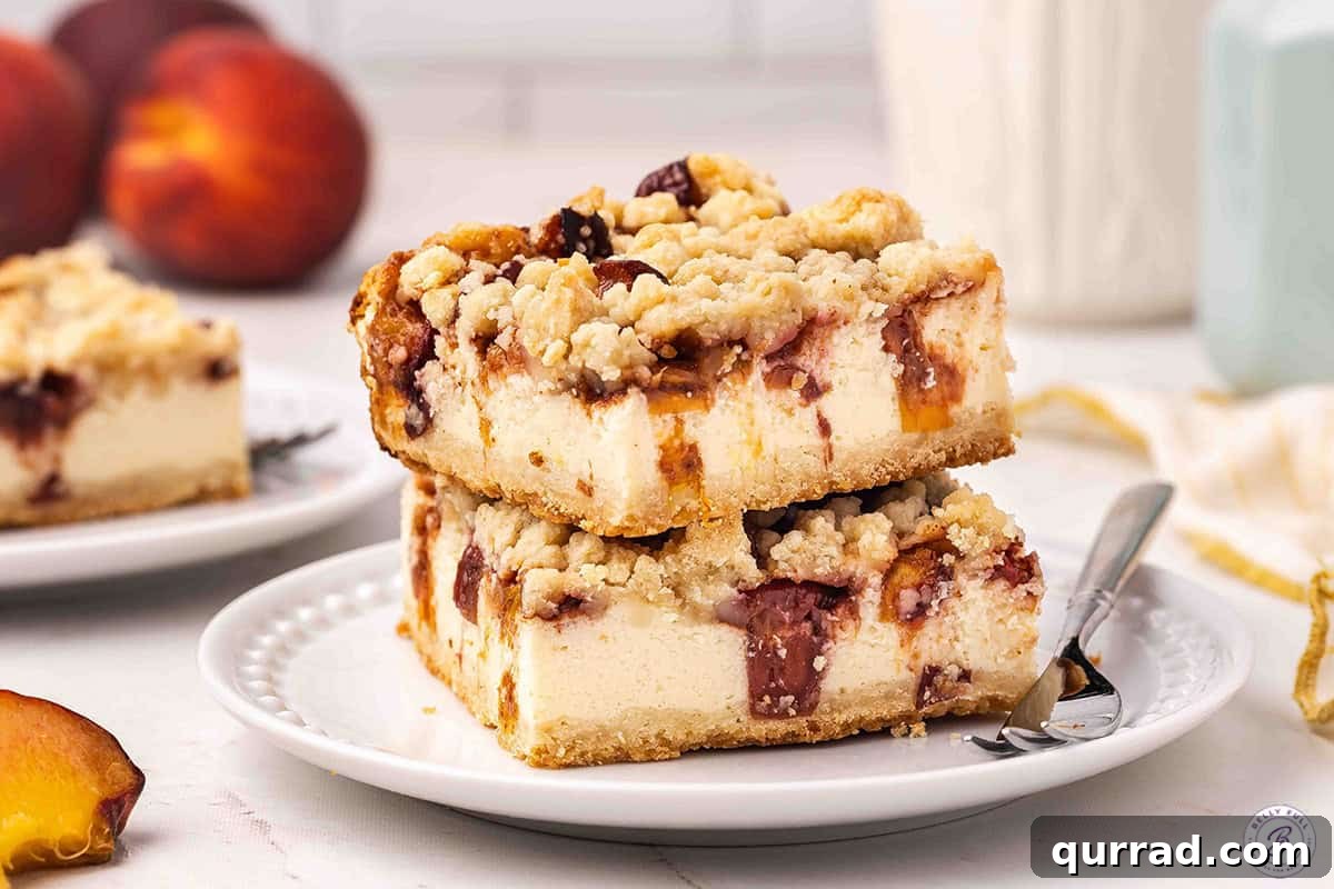 Irresistible Peach Cobbler Cheesecake Bars 12 Side view of a plate of peach cobbler cheesecake bars.