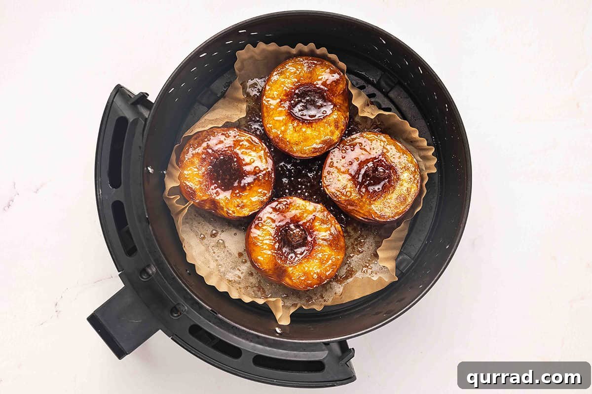 Air Fryer Peaches with Honey and Cinnamon 9 Peaches in an air fryer.