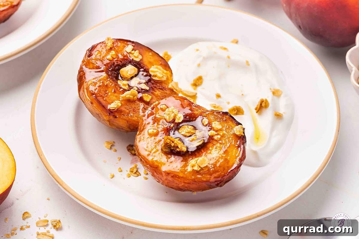 Air Fryer Peaches with Honey and Cinnamon 10 Side view of air fryer peaches on a plate with granola and yogurt.