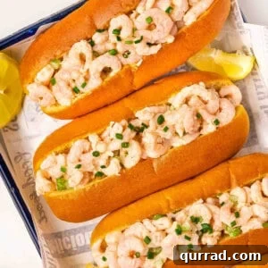 Overhead view of homemade shrimp rolls on a sheetpan.