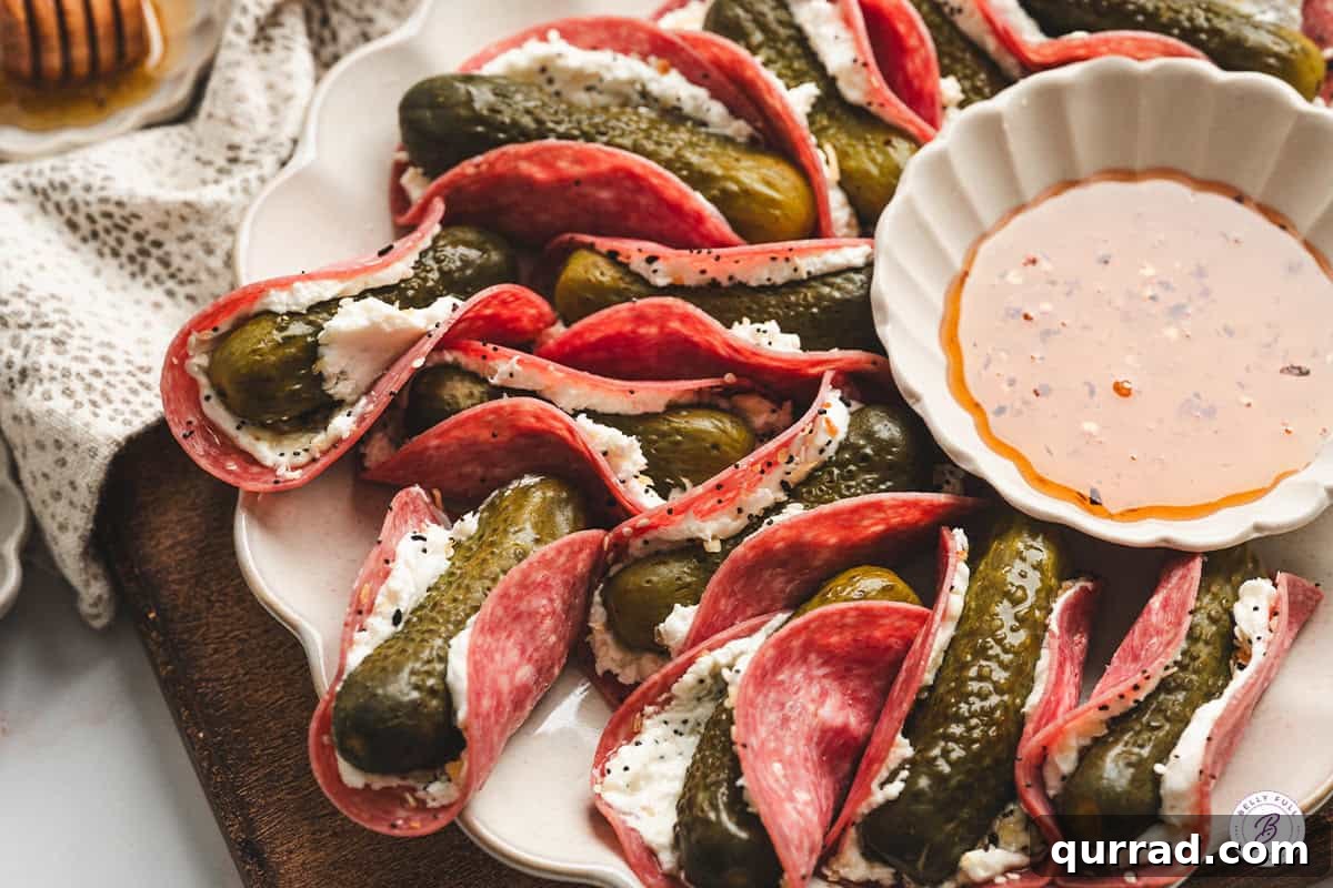 Mini Pickle and Salami Taco Bites 8 A platter of pickle tacos with a bowl of hot honey.