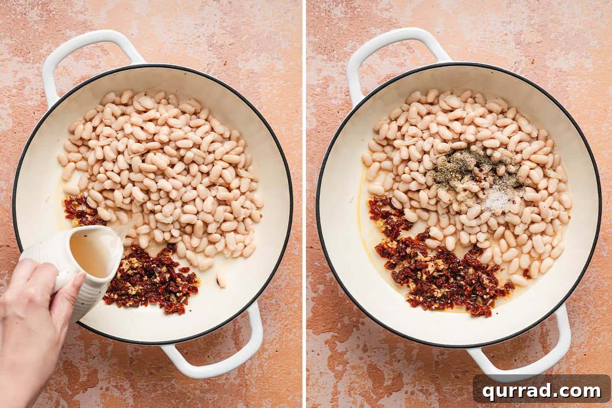 Marry Me Beans: Creamy Tomato and Herb Skillet 6 White beans in a skillet with sauteed sun dried tomatoes and minced garlic with broth being poured in.