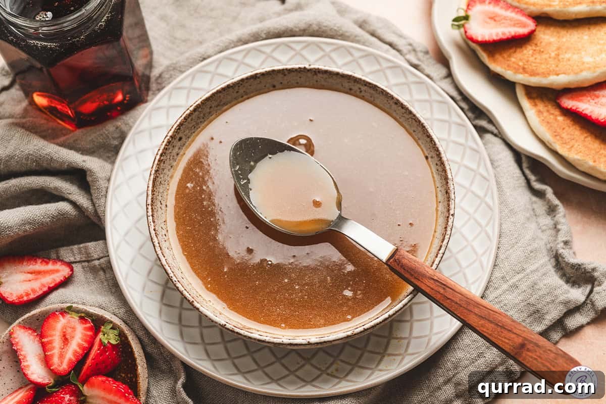 Finished maple butter syrup in a bowl with a spoon.