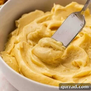 Close up side view of miso butter in a bowl with a knife.