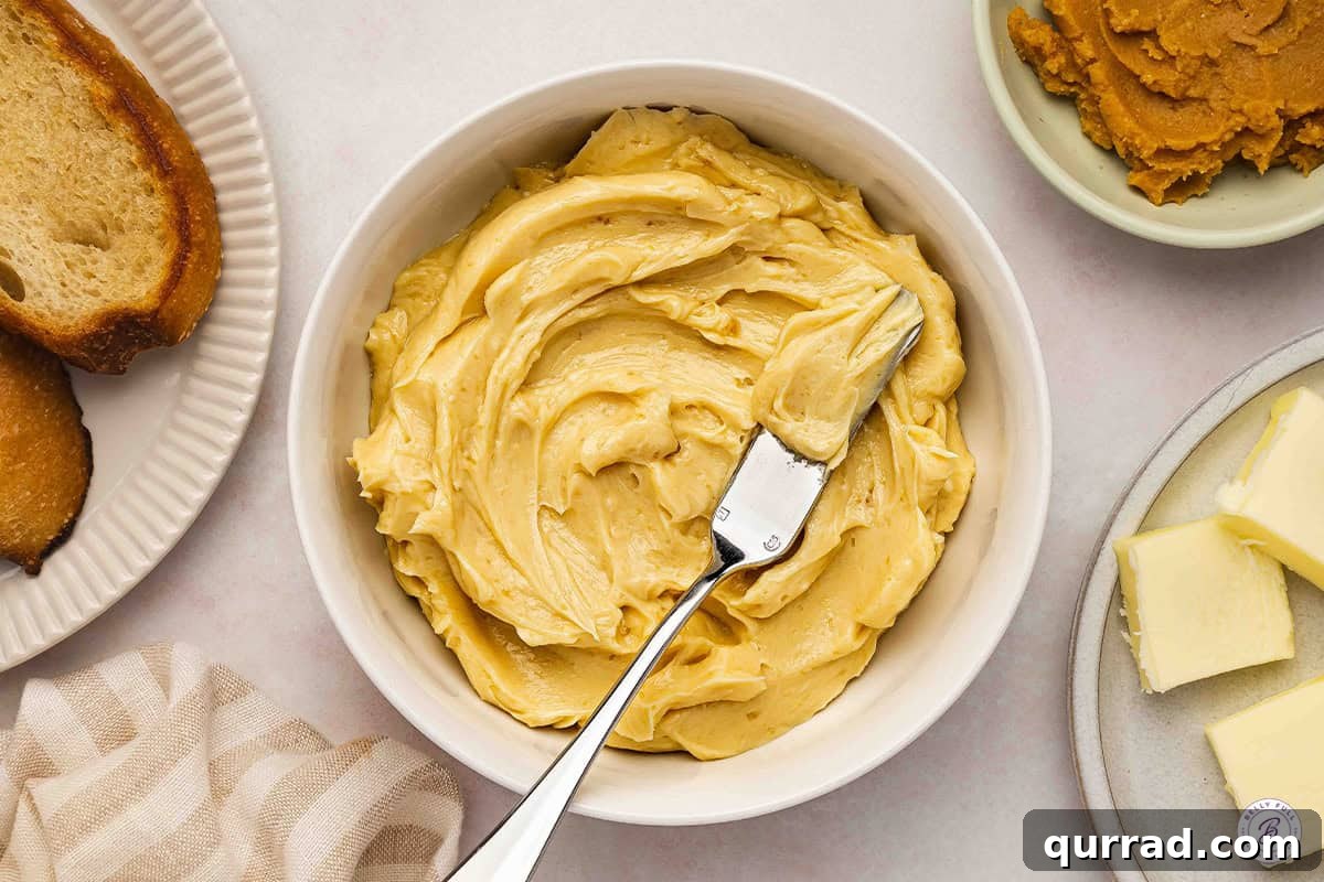Overhead view of a bowl of miso butter with a knife.