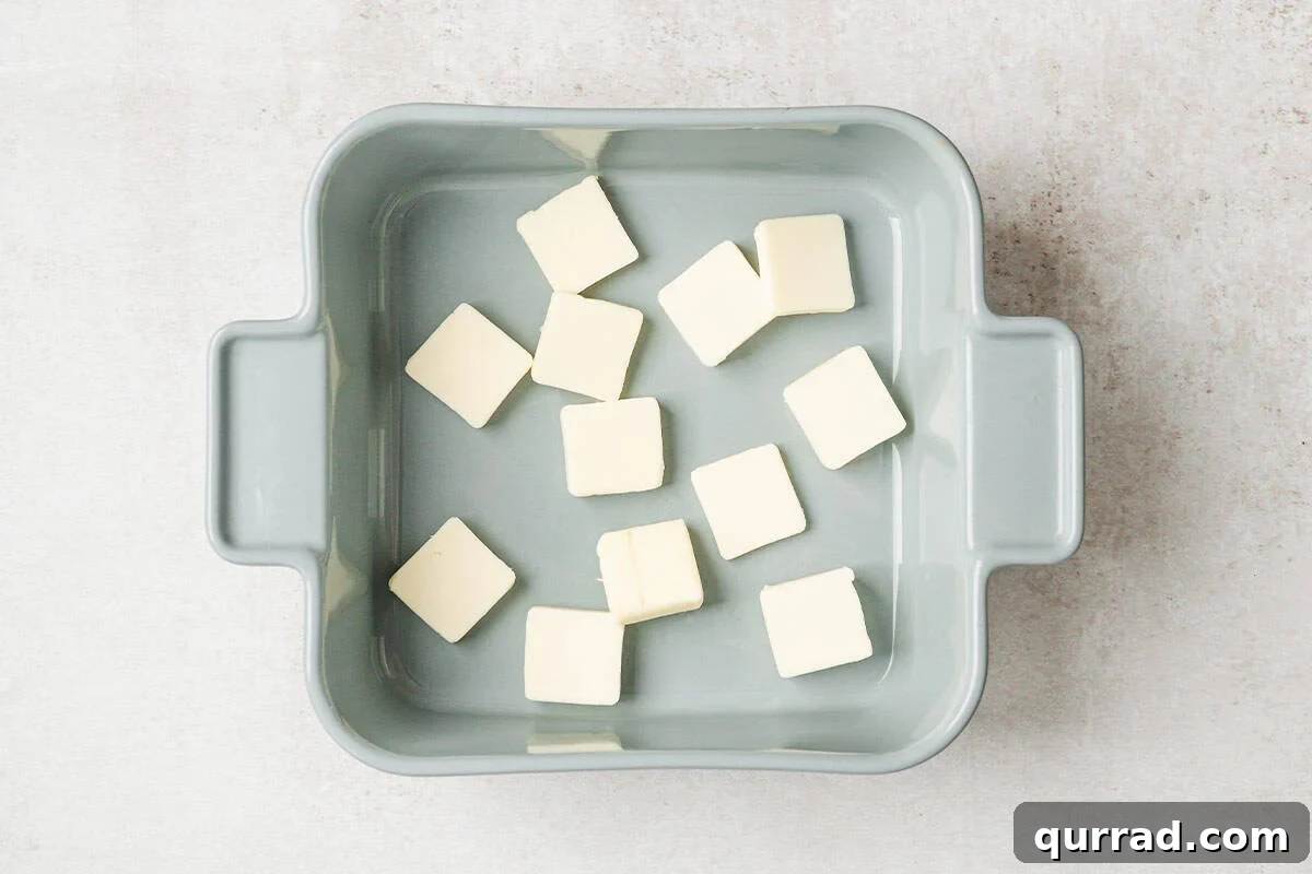 Marry Me Butter Swirl Biscuits 5 Sliced butter in a baking dish.