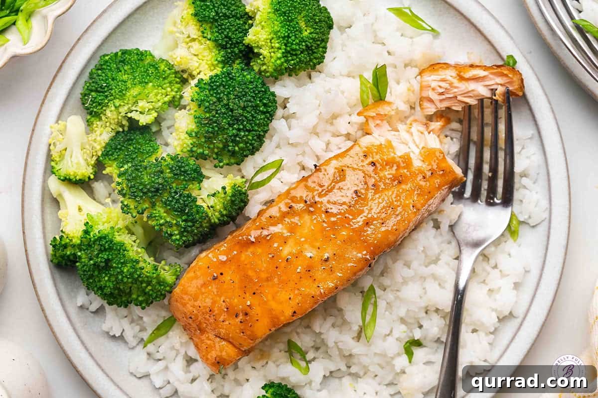 Sticky Brown Sugar-Glazed Salmon Recipe 9 Overhead view of brown sugar glazed salmon on a plate with white rice and broccoli.